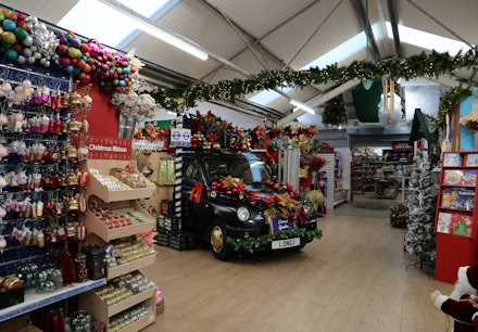 Covent garden taxi parked inside a Christmas display at Longacres Bagshot